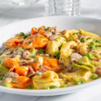 Tortellini Paesano · Mushrooms, peas, and prosciutto in a rich alfredo sauce.