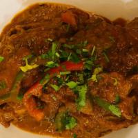 Roasted Lamb Shank · A big piece of lamb shank marinated then slow-roasted in a thick curry sauce, topped with re...