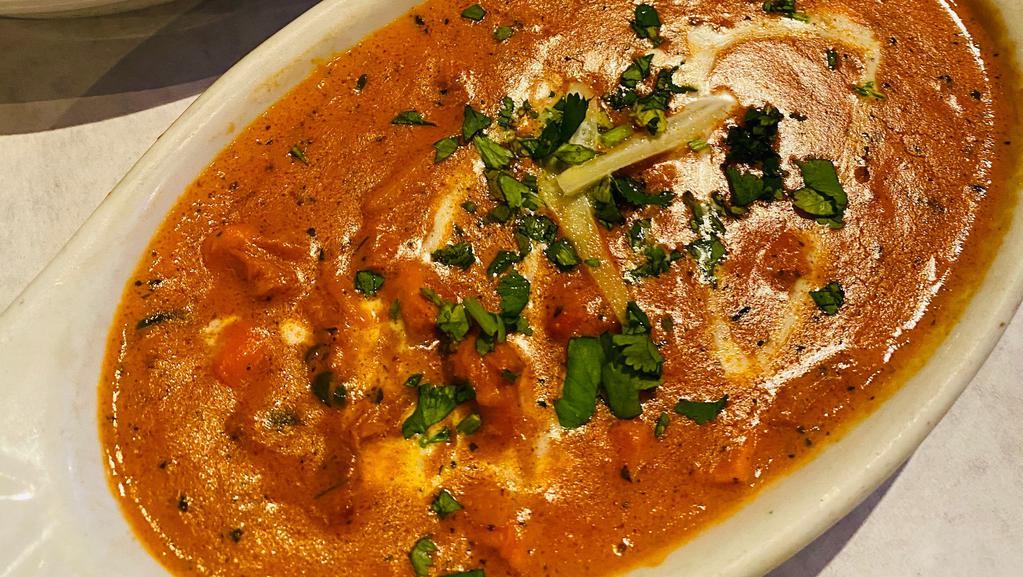 Tandoori Chicken Makhni (Butter Chicken) · Finely cut tandoori chicken tikka sautéed in butter and cooked with blended tomatoes in cream sauce and finely grated cashews served with basmati rice.
