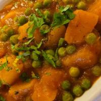 Alu Matar · Fresh potatoes cooked with peas and tomatoes in a special sauce served with basmati rice.