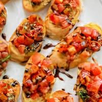 Bruschetta · Refreshing tomato and basil appetizer. Served with balsamic drizzle nestled on top of homema...