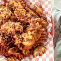 Carol‛S Cheddar Bacon Fries · A house favorite waffle fries smothered in Cheddar sauce, loaded with fresh bacon.