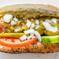 Chicago Dog · Hot dog in a poppy seed bun topped with picked cucumber sport peppers, sliced tomatoes wet r...