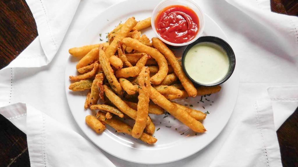 Spicy Pickle Fries · Crispy, tangy thin-cut dill pickle fries lightly coated in a premium cornmeal and spicy horseradish mustard batter. Perfect for adventurous, heat-seeking guests.  Served with our wasabi ranch sauce.