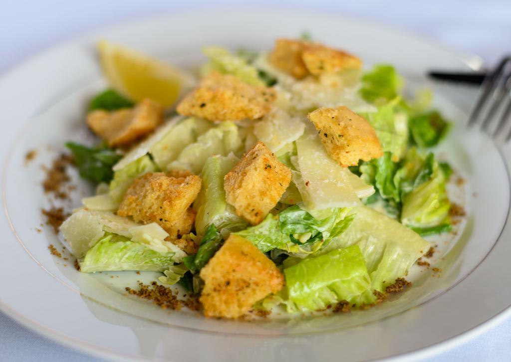 Caesar Salad · Romaine hearts, shaved parmesan cheese, sourdough croutons, housemade caesar dressing, anchovy.