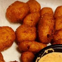 Cheese Curds · A 1/2 lb. of authentic Wisconsin white cheddar cheese curds, beer battered and served with o...