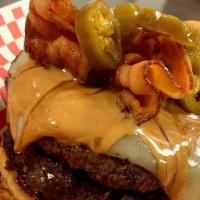 The Pb&J · A flame grilled burger topped w/ pepper Jack cheese, a peanut butter drizzle, jalapeno, baco...