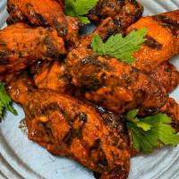 Smoked Chicken Wings · One dozen of our smoked wings served dry or tossed in your choice of Smokeheads Sauces and f...