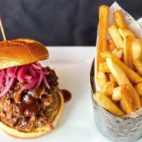 Texas Style Chopped Beef Brisket Sandwich · Each brioche bun sandwich is stacked with a heaping pile of tender, chopped brisket, pickled...