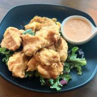 Karaage Chicken · Juicy fried chicken thigh with an original garlic pepper. Served with mixed baby greens and ...