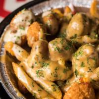 Mac Poutine · Crispy fries, topped with mac sauce and homemade poutine, and fried cheese curds.