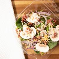 Spinach Salad · Fresh spinach, red onions, bacon, fresh mushrooms, and Feta cheese tossed in a sweet tangy r...