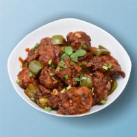 Chicken Manchurian Madness · Chicken morsels cooked and sautéed with chopped onions, peppers, garlic, soy, and chili sauce.