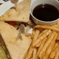 Cabco Sandwich · Shaved prime rib, caramelized onion, roasted red peppers, Swiss & au jus an house baked focc...