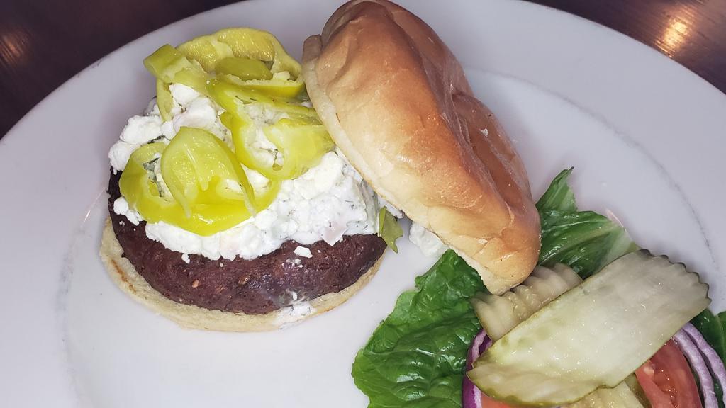 Falafel Sandwich · Falafel patty, topped with cucumber dill sauce, feta, lettuce, tomato, onion and pepperoncini.