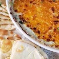 Spinach & Artichoke Dip · Creamy five cheese blend baked to perfection and served with grilled naan bread.