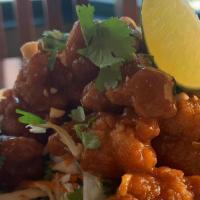 Thai Peanut Shrimp · Crispy breaded shrimp tossed in spicy Thai peanut sauce topped with chopped peanuts, cilantr...