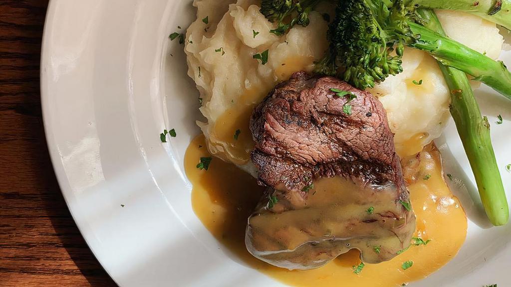 Grilled Filet · Grilled beef tenderloin topped with mushroom demi-glace, served with white cheddar mash & seasonal vegetable