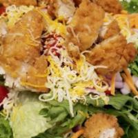 Fried Chicken Salad · Fried chicken tenders over mixed greens, cherry tomatoes, cucumbers, cheddar jack, red onion...