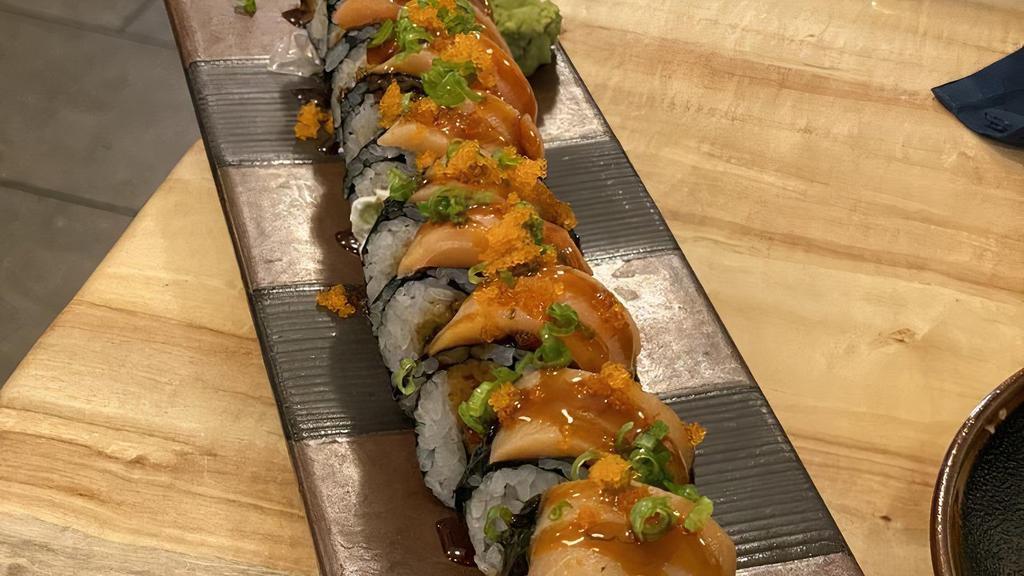 Tootsie Roll · Tempura salmon, avocado, cream cheese, and spicy mayo, topped with smoked salmon, green onion, masago and eel sauce.
