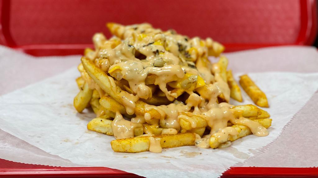 Elite Style Fries · Classic Fries topped with American cheese, caramelized onions & Elite sauce.