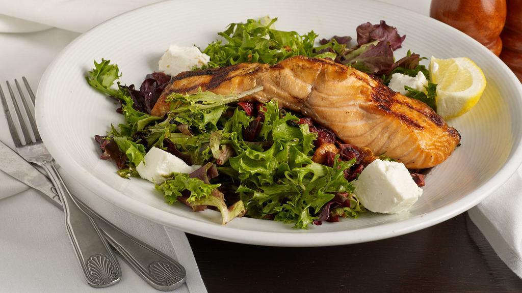 Bloomingdale Salad · Grilled salmon over spring mix with cranberries, goat cheese, and seasoned roasted walnuts, tossed in a balsamic vinaigrette.