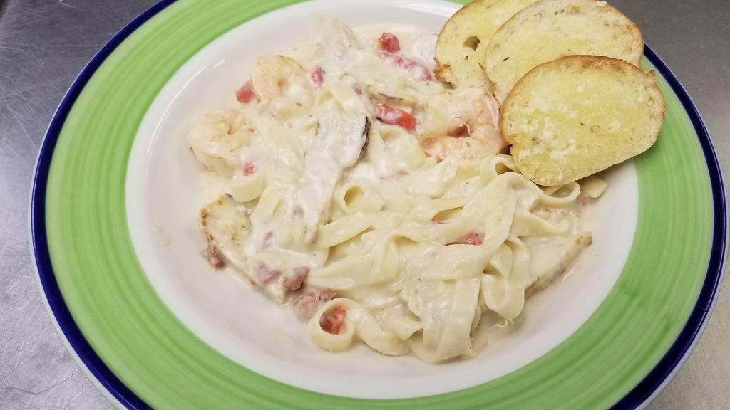 Chicken And Shrimp Carbonara · Grilled Chicken and Gulf Shrimp sauteed with Red Onions, Roasted Red Bell Peppers, and Bacon Crumbles in Homemade Alfredo with penne.