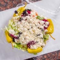 Greek Salad · Crisp lettuce with tomatoes, onion, feta cheese, cucumbers, olives, pepperoncini & beets.