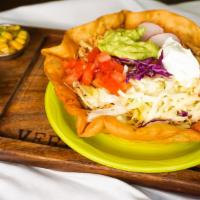 Our Famous Taco Salad · Mixed greens corn black beans tomato cheese cabbage sour cream guacamole.