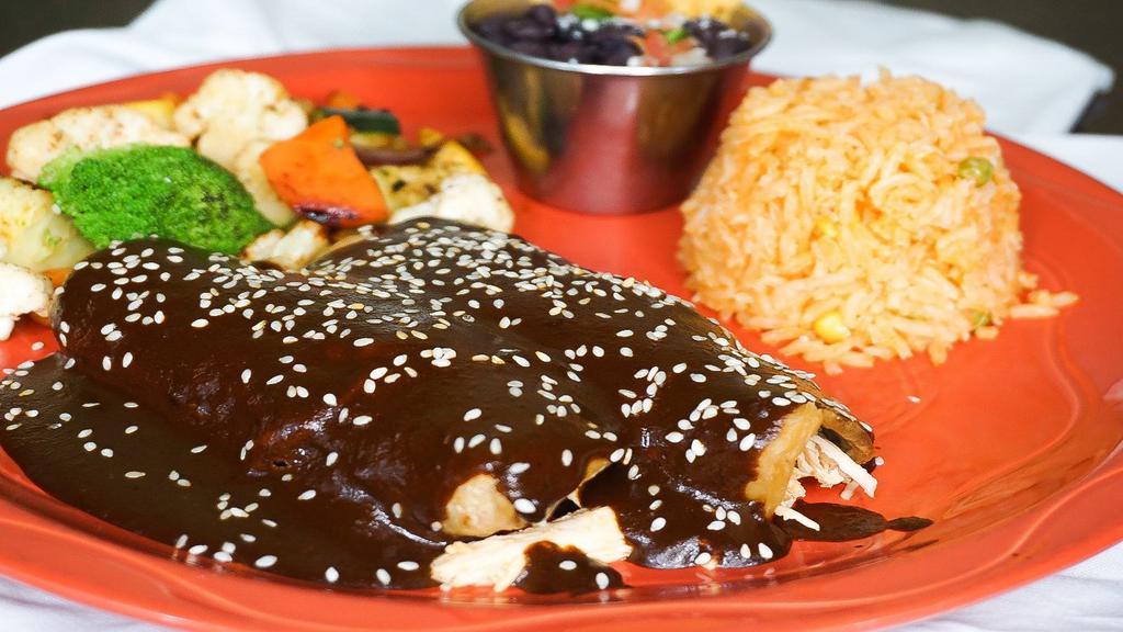 Enchiladas De Mole · Three corn tortillas, chicken and mole sauce. Served with Rice and fried onions.
