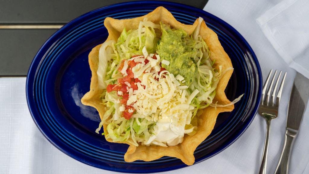 Taco Salad · Choice of beef or chicken with lettuce, tomatoes, sour cream and guacamole piled high in a crispy flour tortilla bowl.