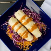 Huracan · Two shrimp enchiladas on flour tortilla, grilled onions, and poblano peppers, covered with c...