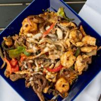 Lindo Special · Steak, shrimp and chicken cooked with onions, belle peppers and mushrooms. Served over a bed...