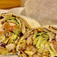 Chicken Shawarma Pita Wrap · Slices of seasoned chicken cooked rotisserie style with garlic sauce, lettuce, cucumbers, sh...