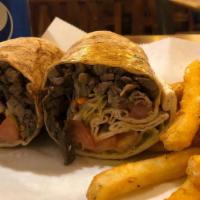Beef Shawarma Pita Wrap · Slices of seasoned sirloin beef cooked rotisserie style with tahini sauce, lettuce, cucumber...