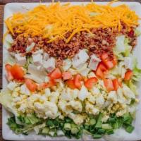 Cobb Salad · Iceberg lettuce topped with diced turkey breast, diced tomatoes, shredded Colby cheese, baco...