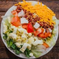 Cobb Salad (Small) · Iceberg lettuce topped with diced turkey breast, diced tomatoes, shredded Colby cheese, baco...