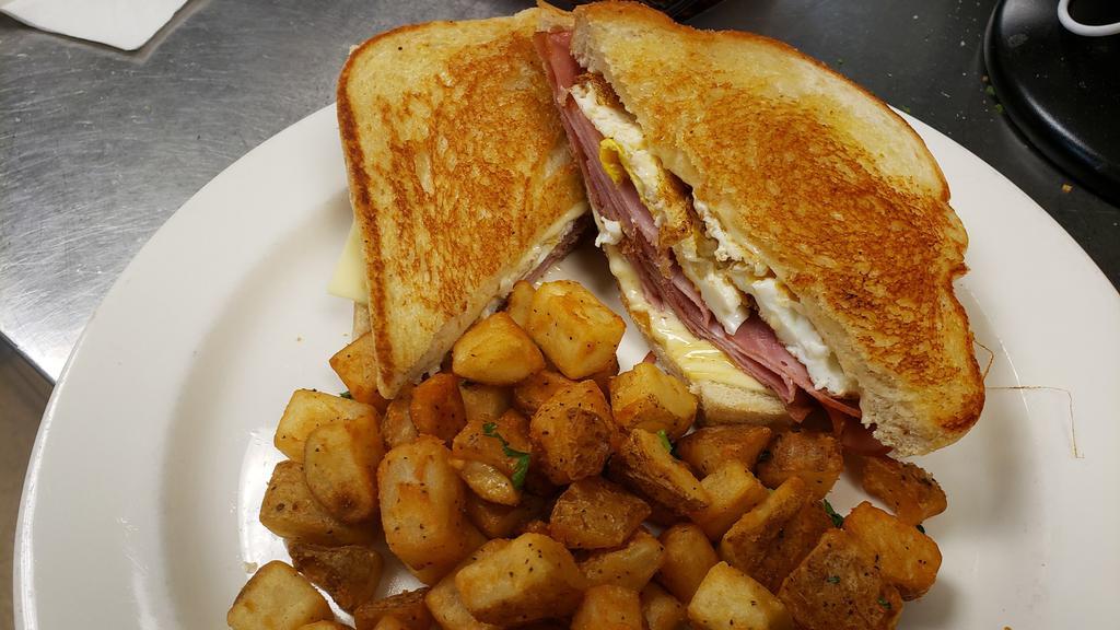 Breakfast Melt · Your choice of Ham, Bacon, or Sausage, 2 fried eggs, Swiss and American cheeses on thick-cut grilled sourdough. Add potato for an additional charge.
