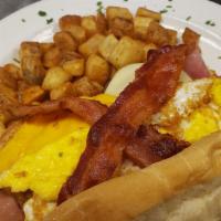 The Triple Stacker Po Boy · Two fried eggs, Ham, Bacon, and sausage stuffed in a French loaf with melted Swiss and Ameri...