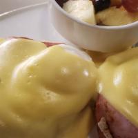 Classic Eggs Benedict · Hard to beat the Classic!  English Muffin, Canadian Bacon, eggs, and Hollandaise.  Served wi...