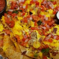 Breakfast Nachos · Crispy tortilla chips layered with scrambled eggs, bacon, sausage, and House Queso finished ...