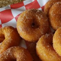 Cinnamon Sugar Donuts · A dozen mini donuts fried to order and tossed in cinnamon sugar.