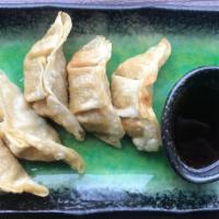 Gyoza (5 Pcs) · Fried or steamed ground pork and cabbage dumplings.