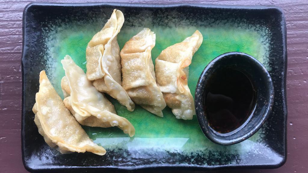 Gyoza (5 Pcs) · Fried or steamed ground pork and cabbage dumplings.