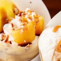Coco Mango · Mango, whipped cream, roasted coconut flakes, chocolate sauce, mango mochi.