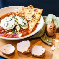 Eggs In Purgatory · soft poached eggs in a spicy, rich tomato sauce with roasted red peppers, spinach, kalamata ...