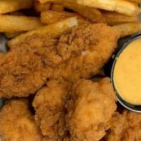 Chicken Tender Basket · Chicken tenders battered and fried to golden brown, and served with French fries