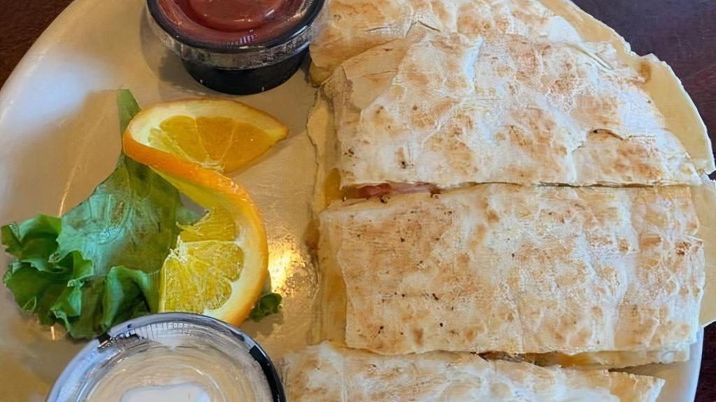 Grilled Chicken Quesadilla · Grilled flour tortilla loaded with chicken, melted cheddar and jack cheese and veggies. Served with salsa and sour cream