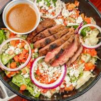 Black & Bleu Salad · Chargrilled steak seasoned with cajun spices, sliced and set atop greens with tomatoes, onio...