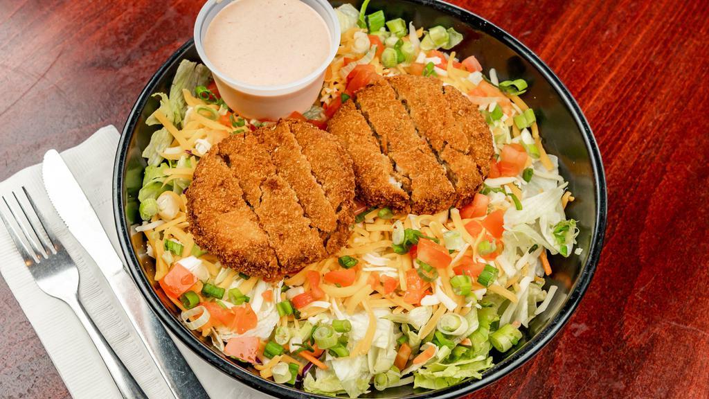 Crab Cake Salad · Two of our famous crab cakes fried and served on a bed of lettuce, with cheddar and jack cheese, tomatoes, green onions and our homemade crab Louis dressing on the side.